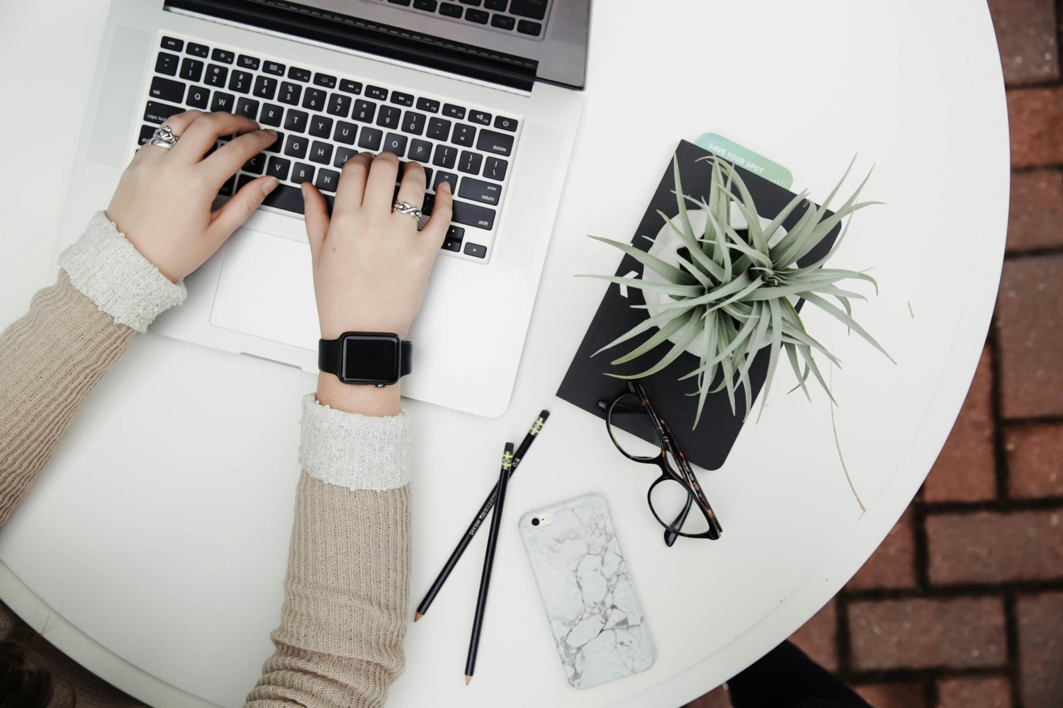 Laptop and notebook on a desk, website hosting and care